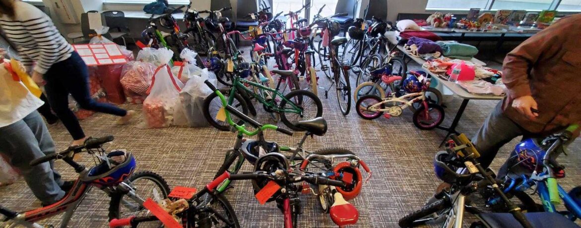 A holiday party with kids’ bikes and families